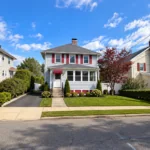 Completed exterior painting and siding project on a colonial-style home