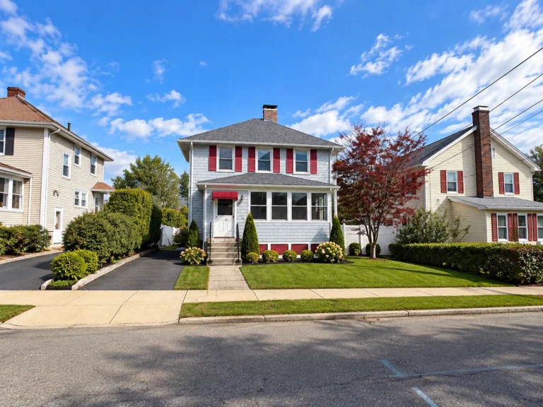 Completed exterior painting and siding project on a colonial-style home