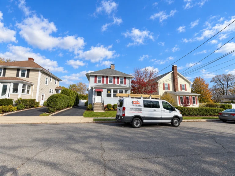 King of Remodeling work van parked in front of a completed exterior remodeling project